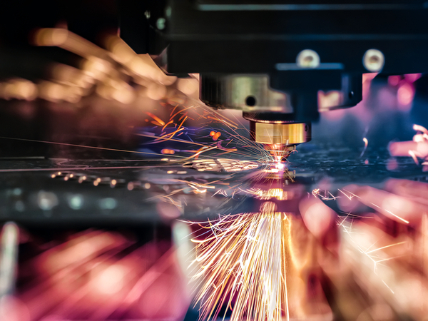 laser cutting machine cutting a piece of sheet metal